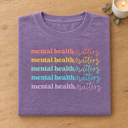 Mental Health Matters rainbow shirt in Orchid Comfort Colors neatly folded
