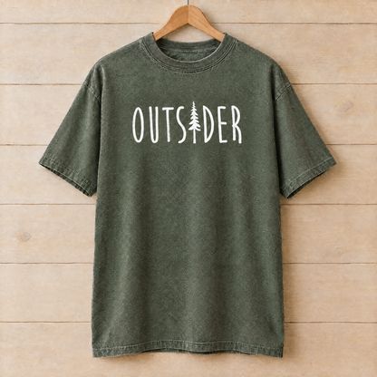 Outsider camping shirt with pine tree in Moss Comfort Colors on a wooden hanger