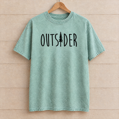 Outsider camping shirt with pine tree in Seafoam Comfort Colors on a wooden hanger
