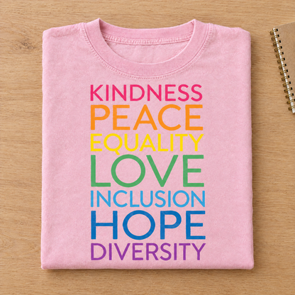 Kindness Peace Equality Love rainbow words shirt in Pink/Blossom Comfort Colors neatly folded