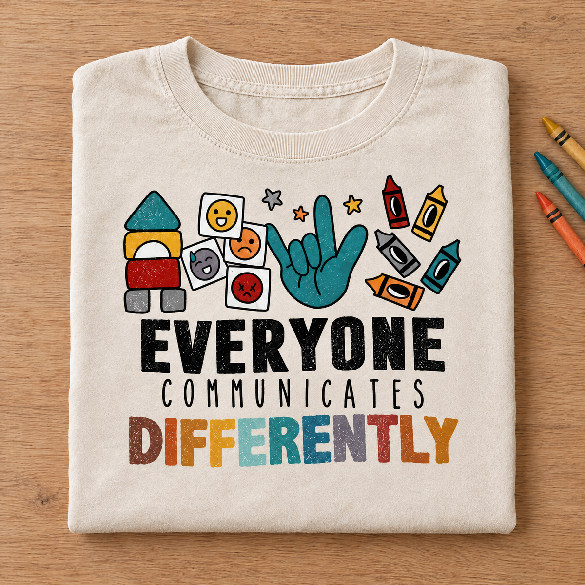 Everyone Communicates Differently autism acceptance shirt in Natural/Ivory Comfort Colors neatly folded