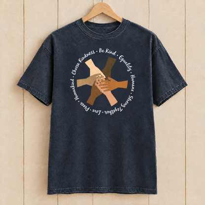 Choose Kindness diverse hands circle shirt in Midnight Comfort Colors on a wooden hanger