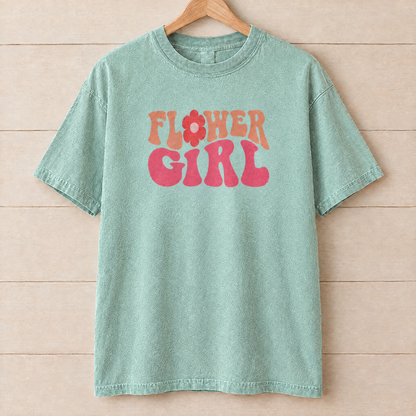 Flower Girl retro groovy shirt in Seafoam Comfort Colors on a wooden hanger