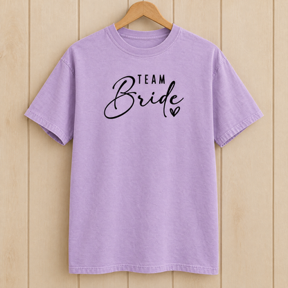 Team Bride shirt in Orchid Comfort Colors on a wooden hanger