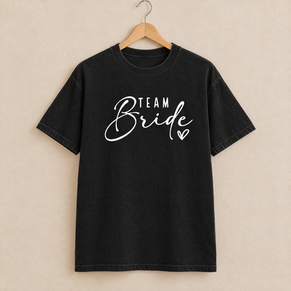 Team Bride shirt in Black Comfort Colors on a wooden hanger