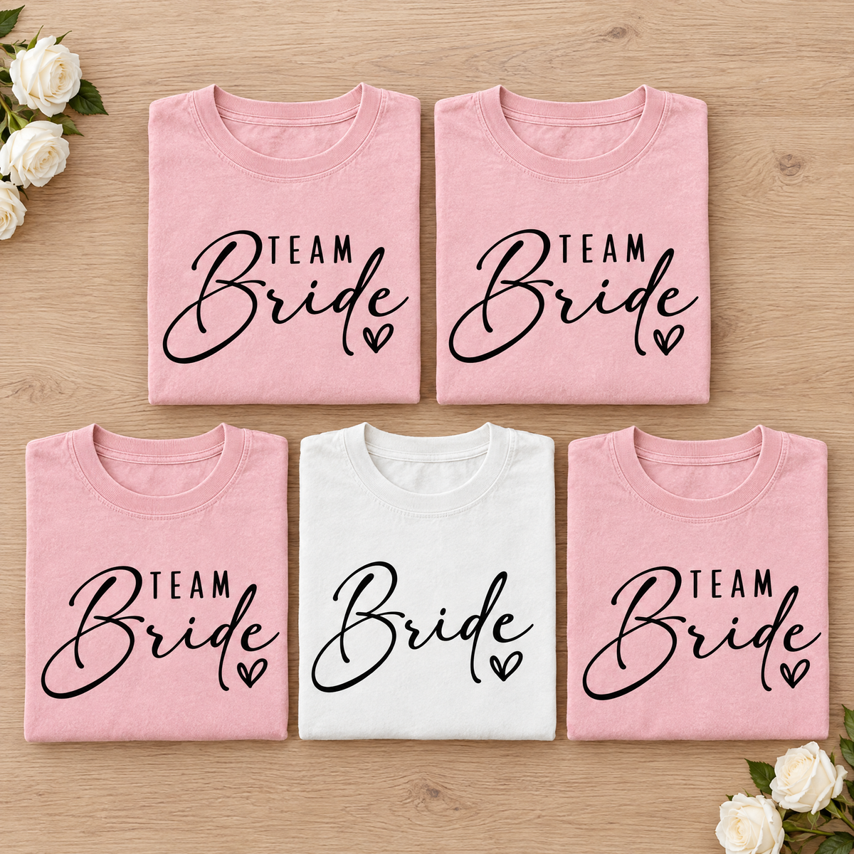 Bachelorette party shirt set, White Bride tee with four Blossom Team Bride tees neatly folded