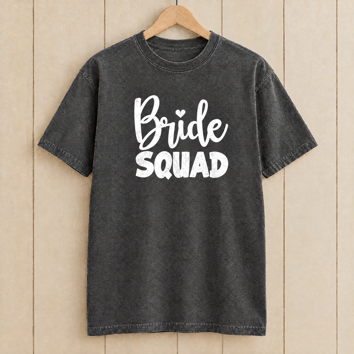 Bride Squad shirt in Pepper Comfort Colors on a wooden hanger
