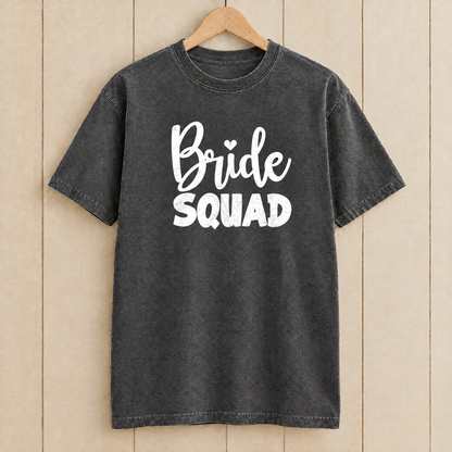 Bride Squad shirt in Pepper Comfort Colors on a wooden hanger