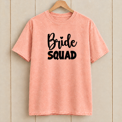 Bride Squad shirt in Peachy Comfort Colors on a wooden hanger