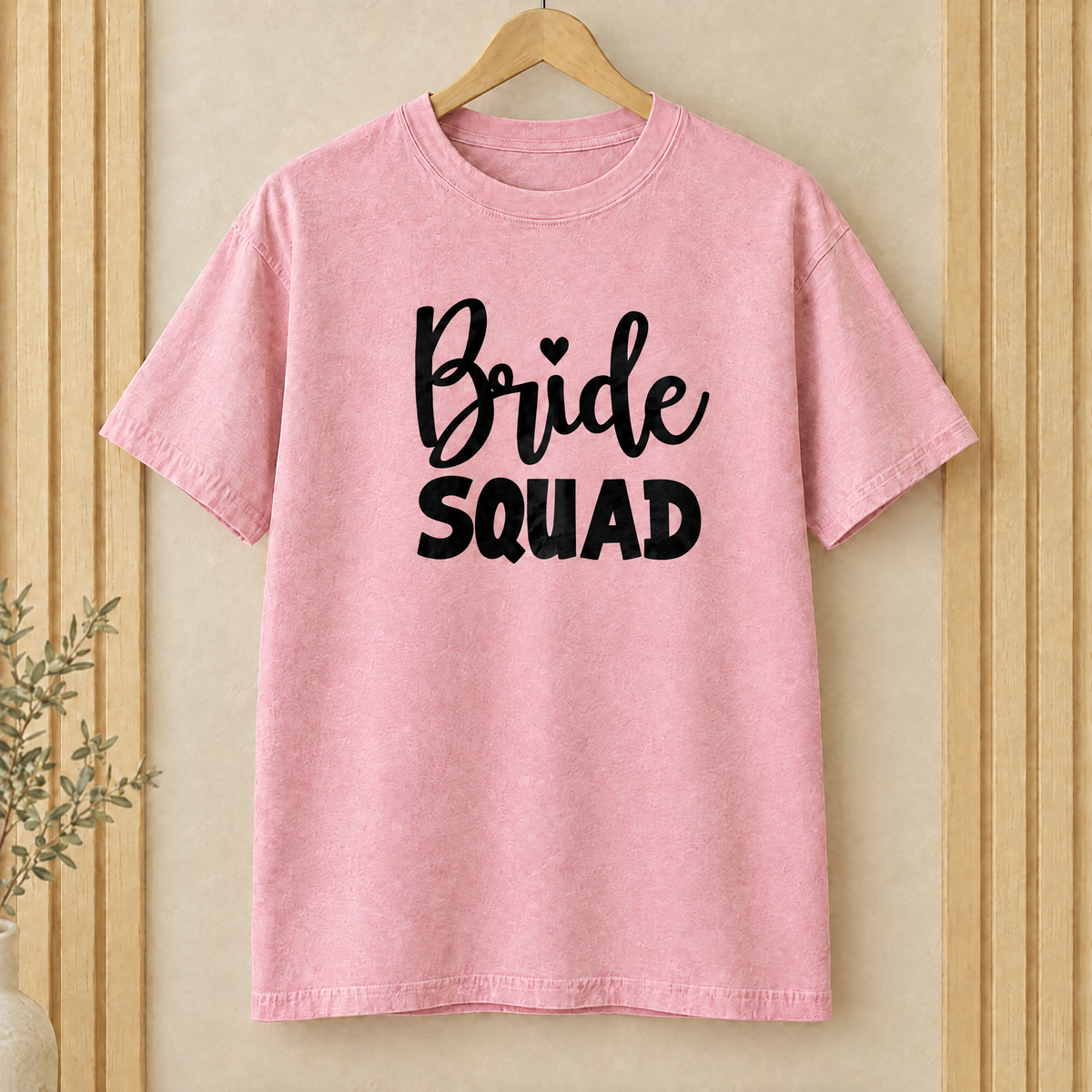 Bride Squad shirt in Blossom Comfort Colors on a wooden hanger