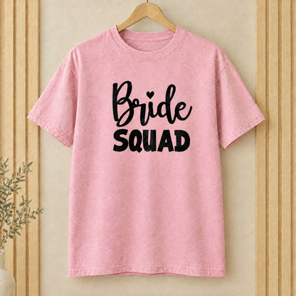 Bride Squad shirt in Blossom Comfort Colors on a wooden hanger