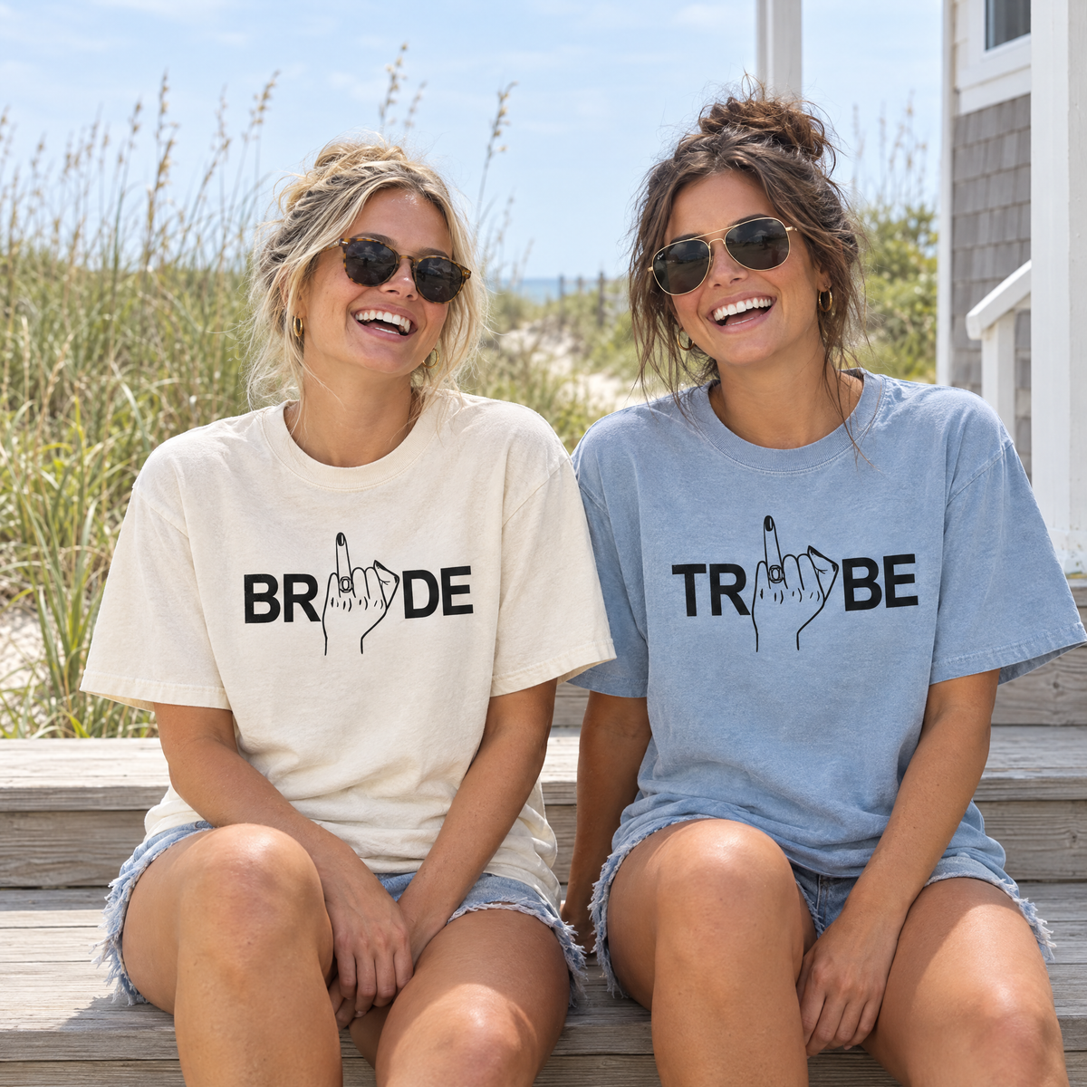 Bride in a Natural Ivory Bride shirt and best friend in a Chambray Tribe shirt on beach house steps