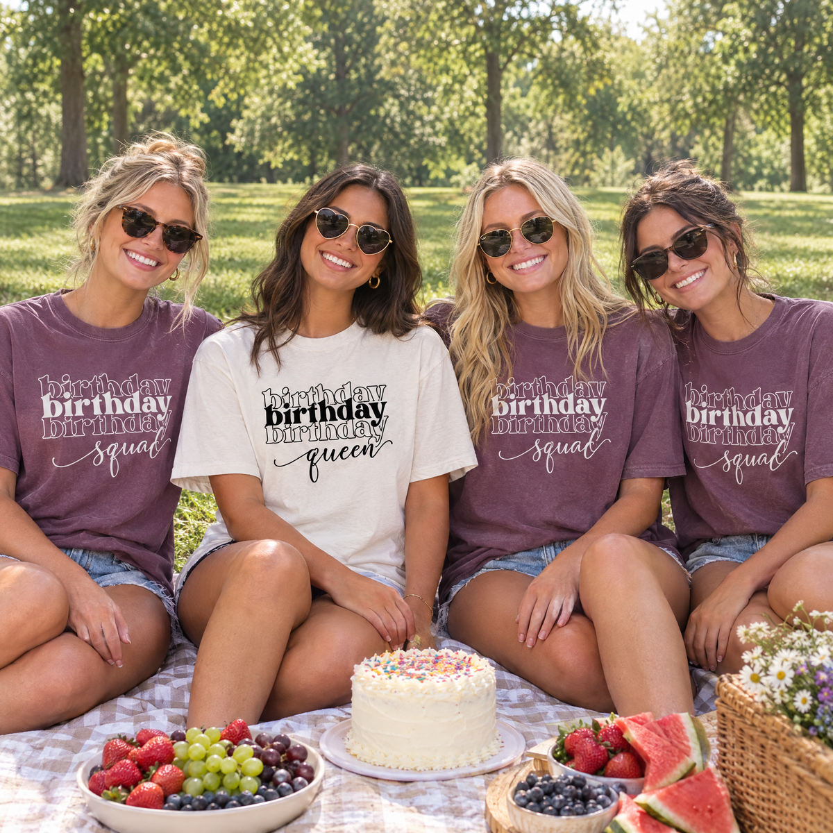 Birthday girl in a White Birthday Queen shirt with three friends in Grape Birthday Squad shirts at a park picnic