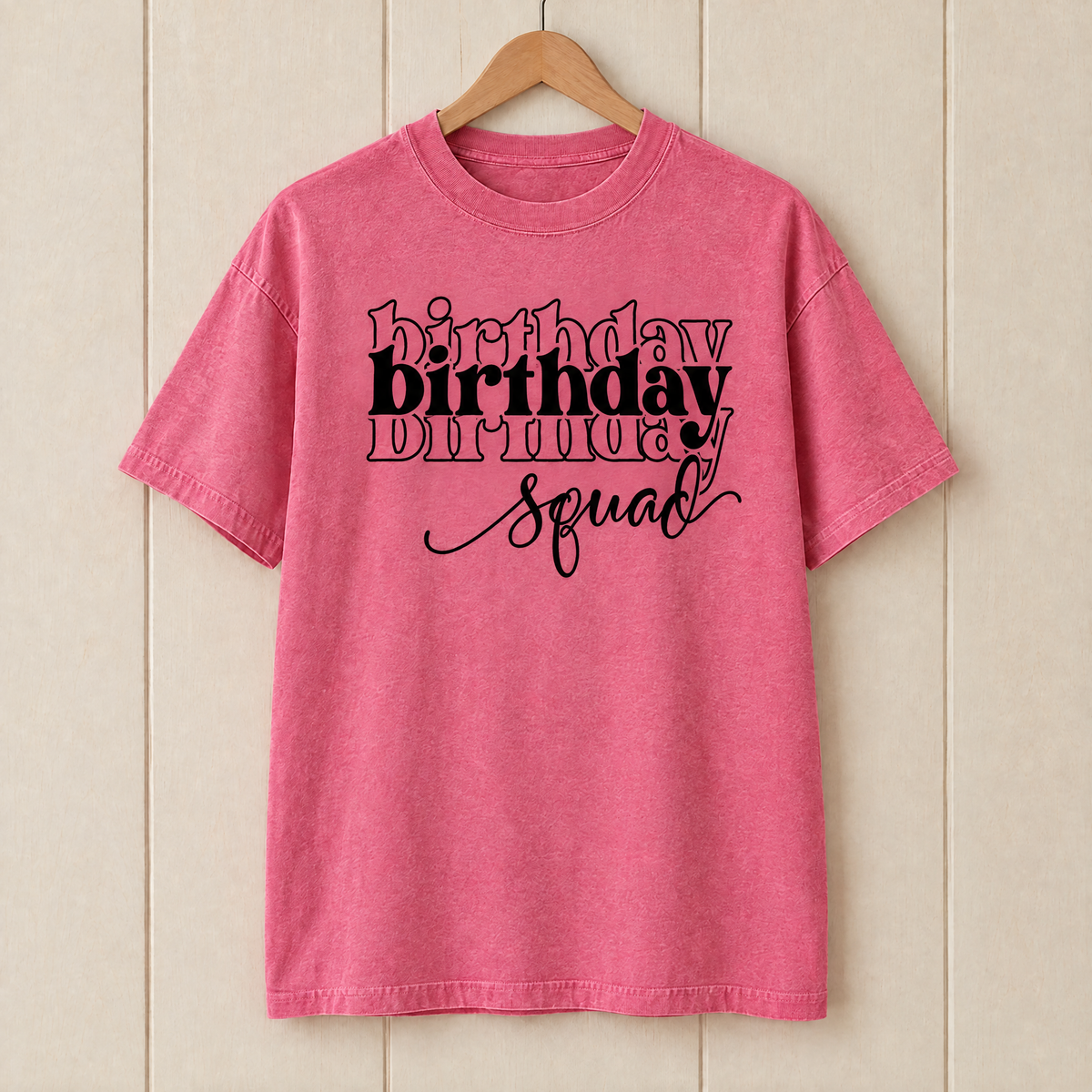 Birthday Squad shirt in Crunchberry Comfort Colors on a wooden hanger