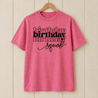 Birthday Squad shirt in Crunchberry Comfort Colors on a wooden hanger