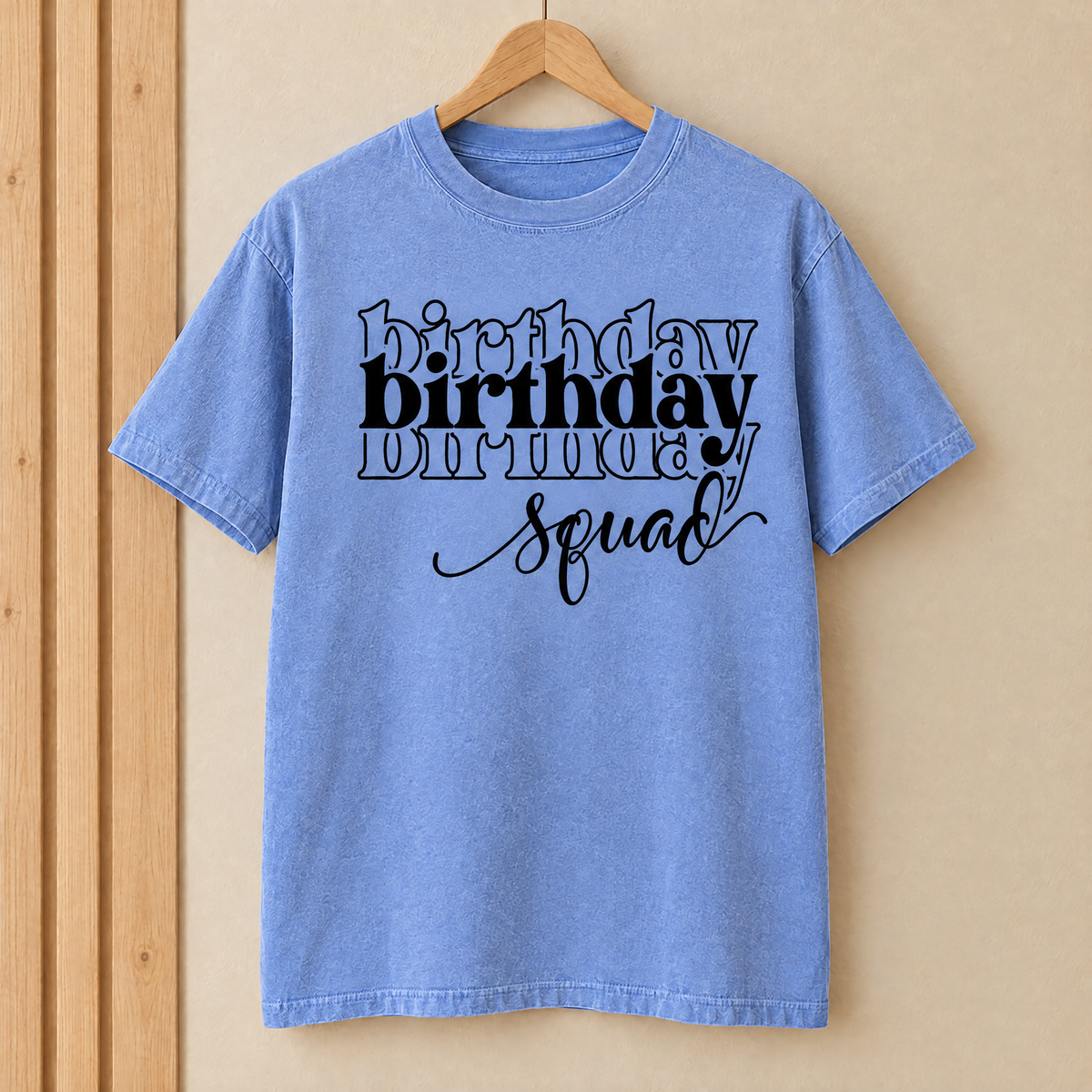 Birthday Squad shirt in Flo Blue Comfort Colors on a wooden hanger