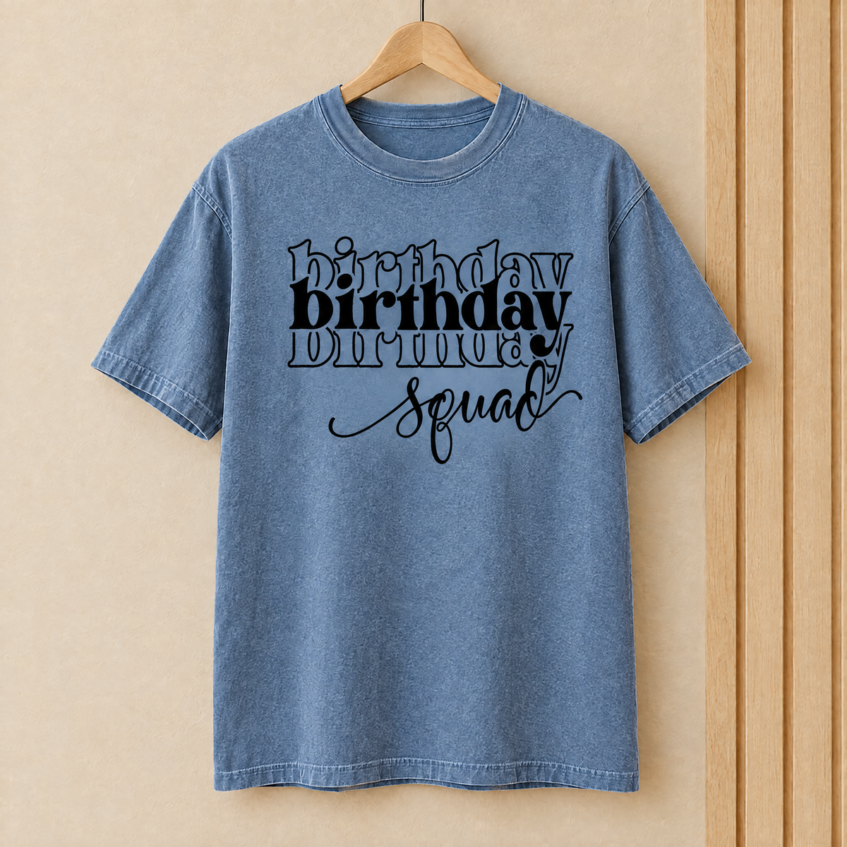 Birthday Squad shirt in Blue Jean Comfort Colors on a wooden hanger