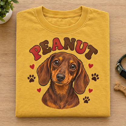 Custom dachshund shirt in Mustard Comfort Colors with a cartoon portrait of Peanut, neatly folded