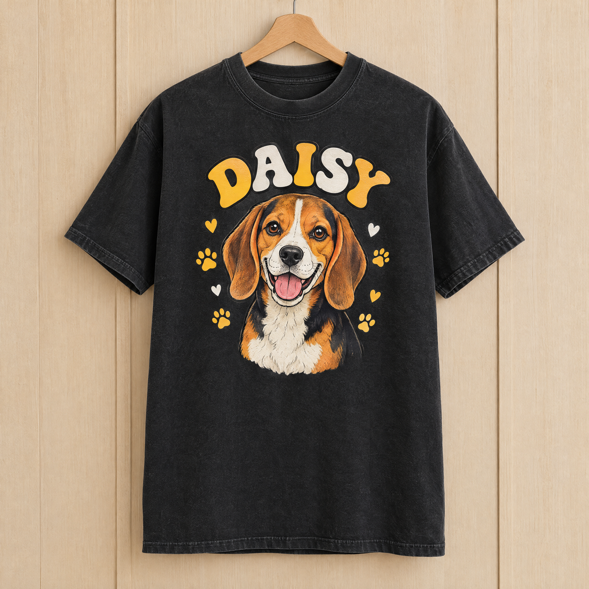 Custom beagle shirt in Black Comfort Colors with a cartoon portrait of Daisy on a wooden hanger