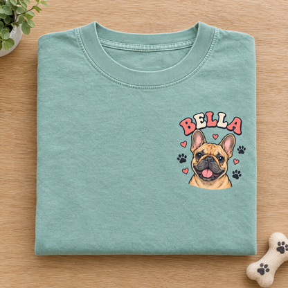 Pocket pet portrait shirt in Seafoam Comfort Colors with a small cartoon French bulldog named Bella, neatly folded