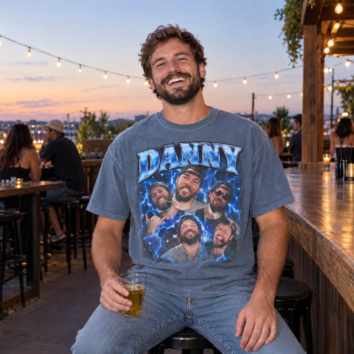 Man at a bar patio wearing a Blue Jean Comfort Colors bootleg shirt with a chrome blue photo collage of his best friend Danny