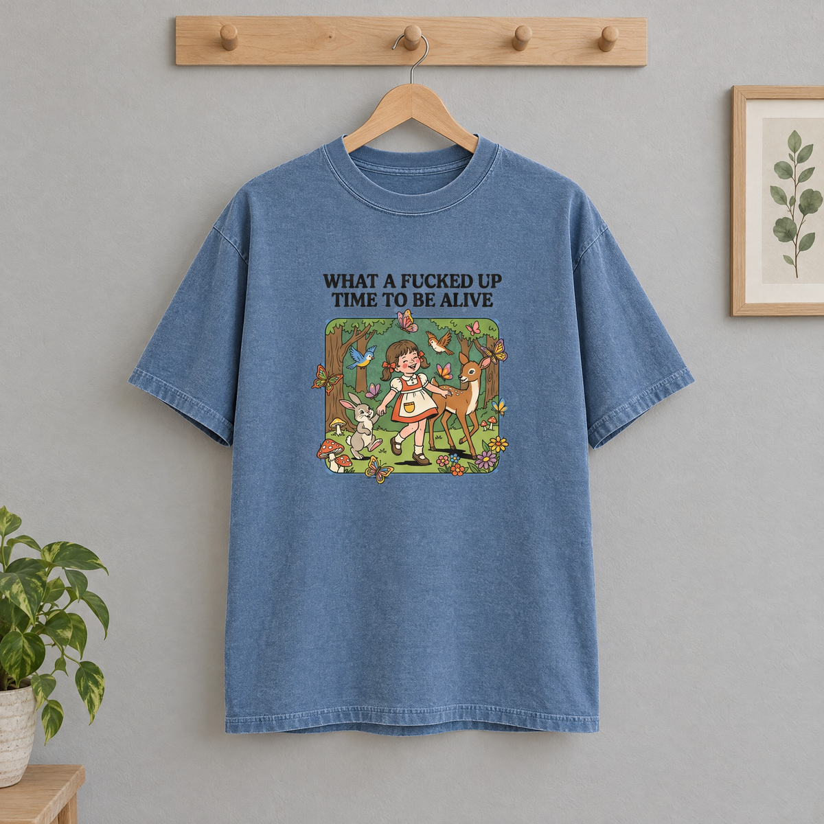What a Time to Be Alive Comfort Colors shirt in Blue Jean on a wooden hanger