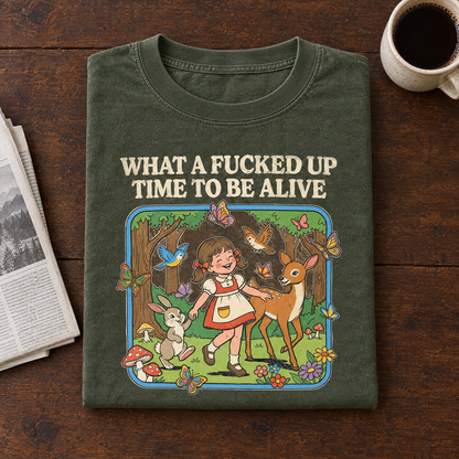 Funny dark humor tee in Moss, folded with a newspaper and black coffee