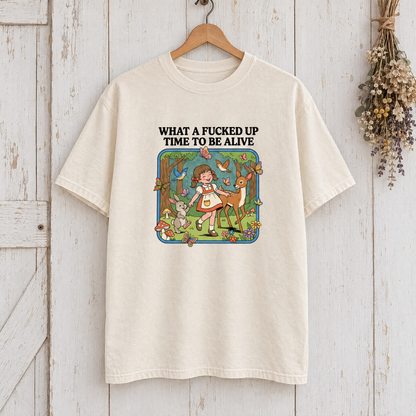 What a Time to Be Alive Comfort Colors shirt in Natural Ivory on a wooden hanger