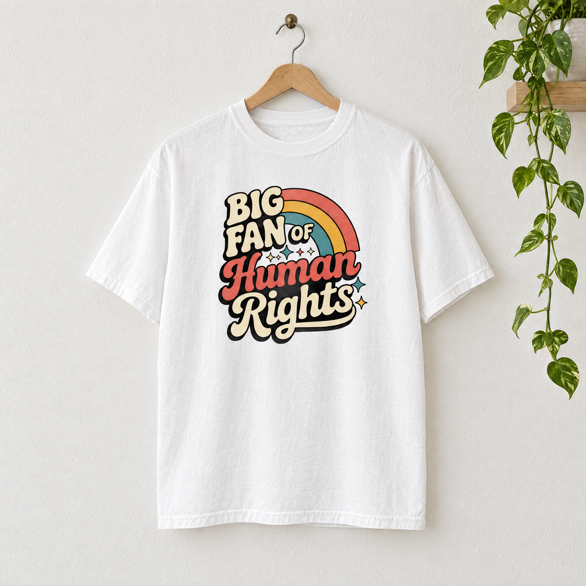 Big Fan of Human Rights retro rainbow Comfort Colors shirt in White on a wooden hanger