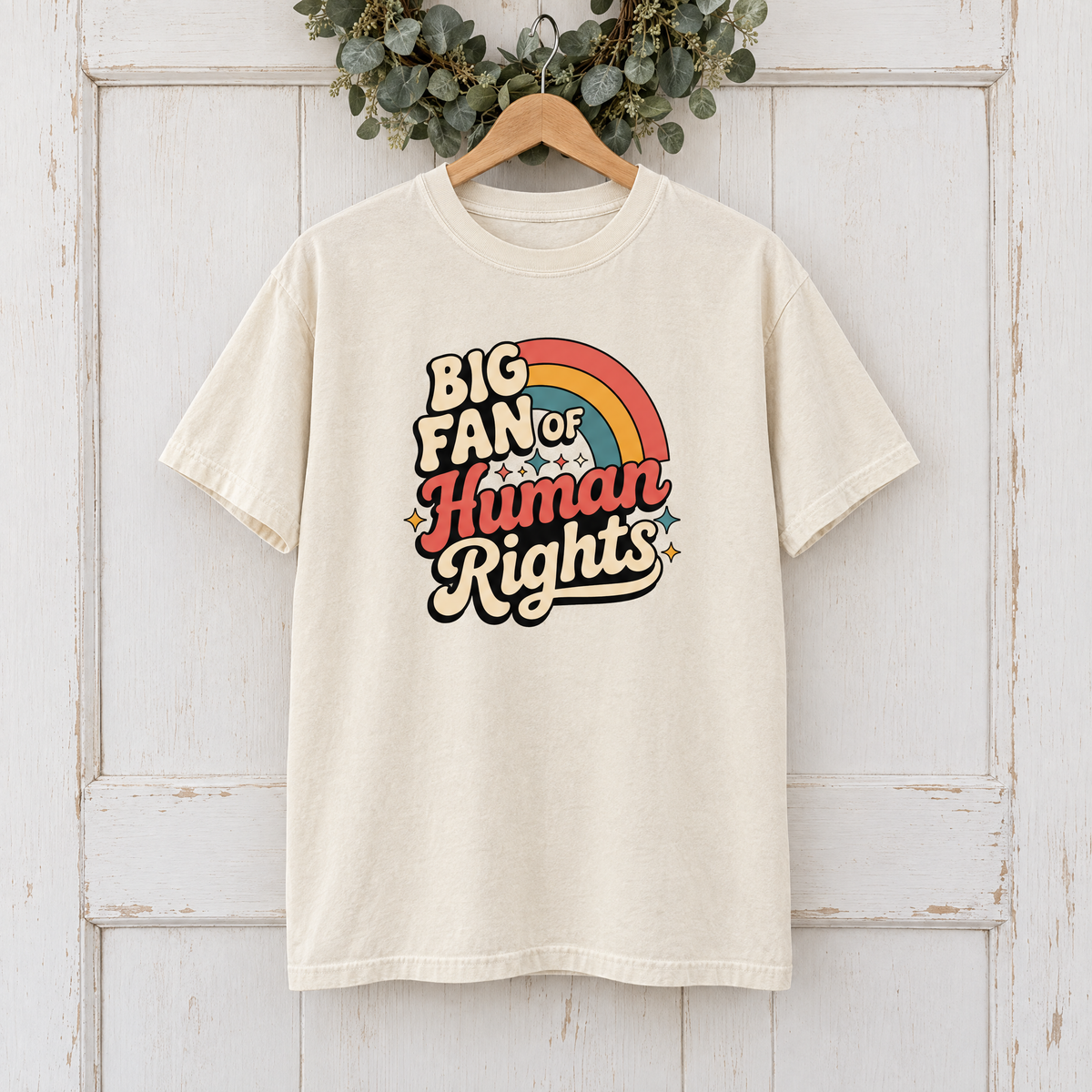 Big Fan of Human Rights Comfort Colors shirt in Natural Ivory on a wooden hanger