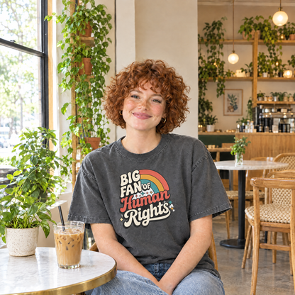Woman wearing Pepper Comfort Colors Big Fan of Human Rights shirt in a cafe