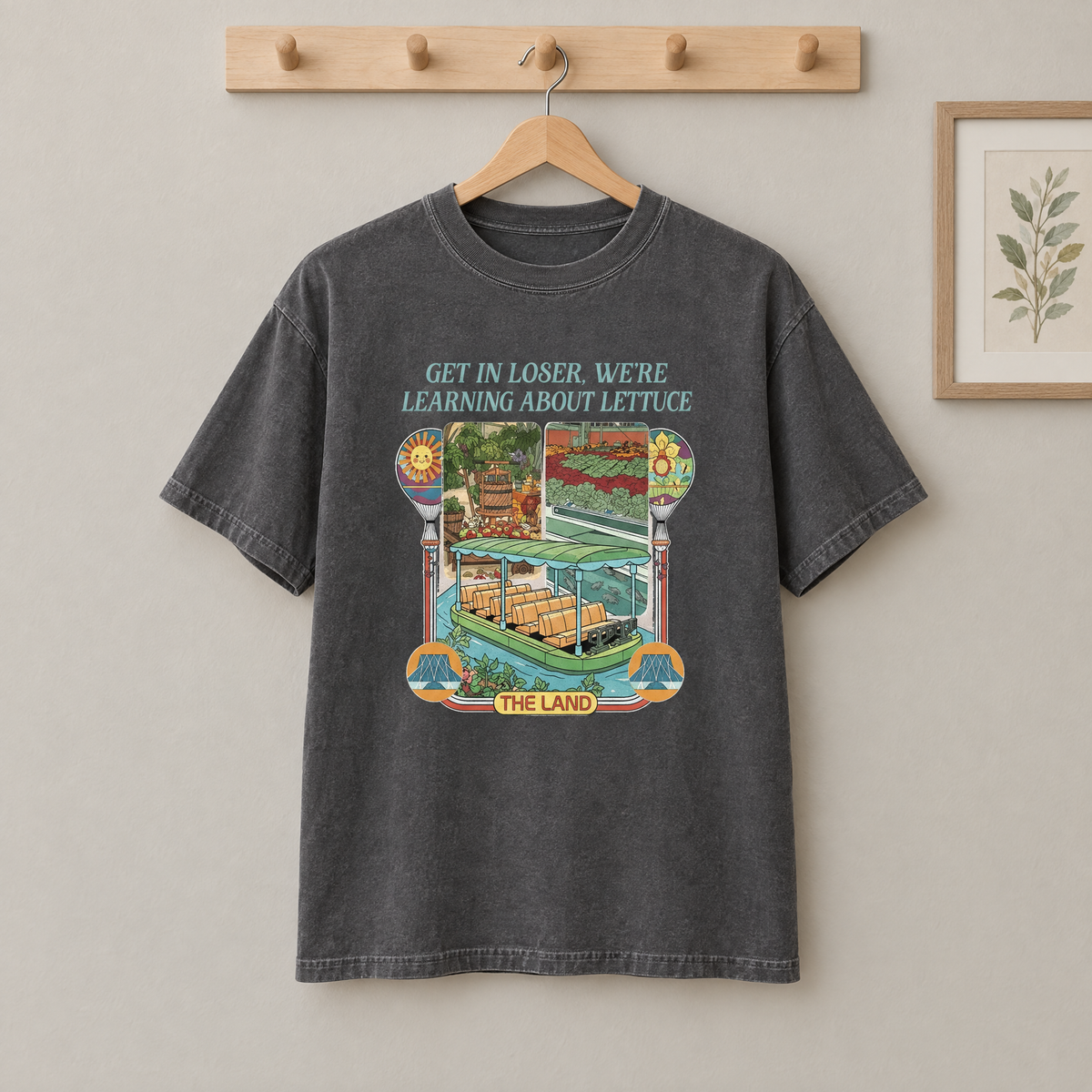 Pepper grey Learning About Lettuce shirt hanging on a wooden peg rail