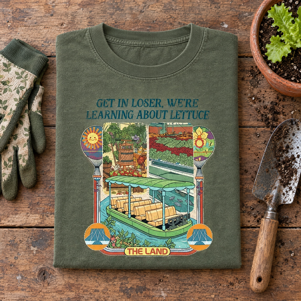 Moss Learning About Lettuce shirt folded on a potting bench with gardening gloves and a trowel