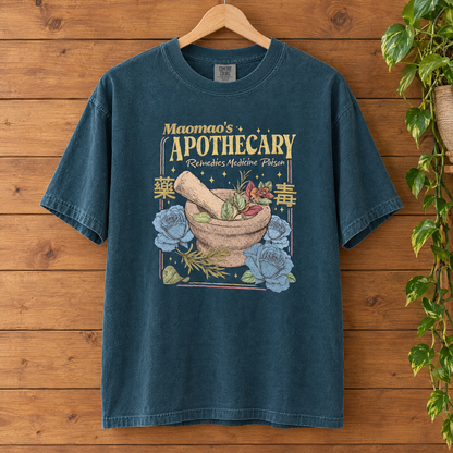 Maomao's Apothecary Comfort Colors shirt in Blue Spruce on a wooden hanger