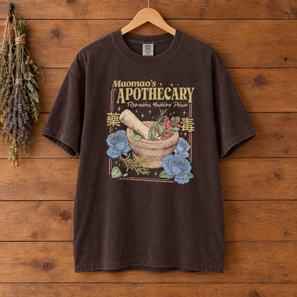 Maomao's Apothecary Comfort Colors shirt in Espresso on a wooden hanger