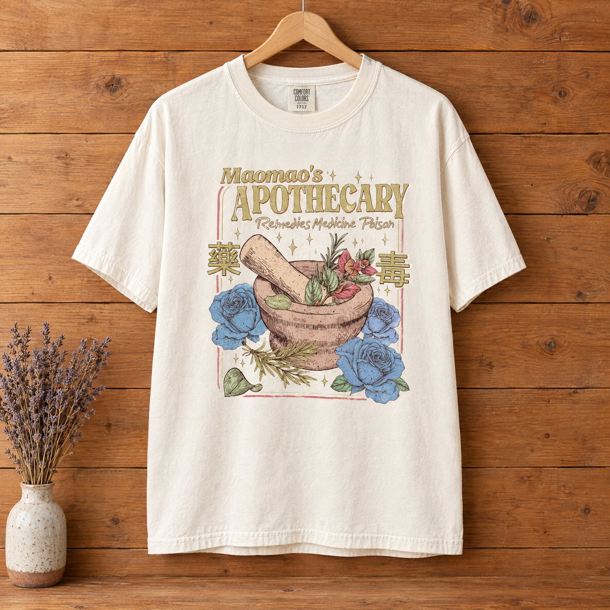 Maomao's Apothecary Comfort Colors shirt in Natural Ivory on a wooden hanger
