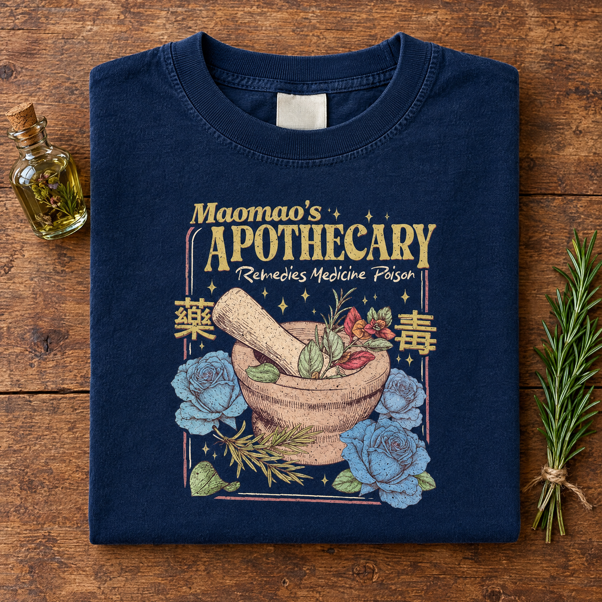 Kawaii anime apothecary tee in Navy, folded with a potion bottle and rosemary