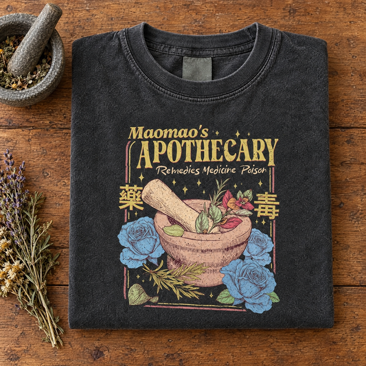 Kawaii anime apothecary tee in Pepper, folded with a mortar and pestle and dried herbs