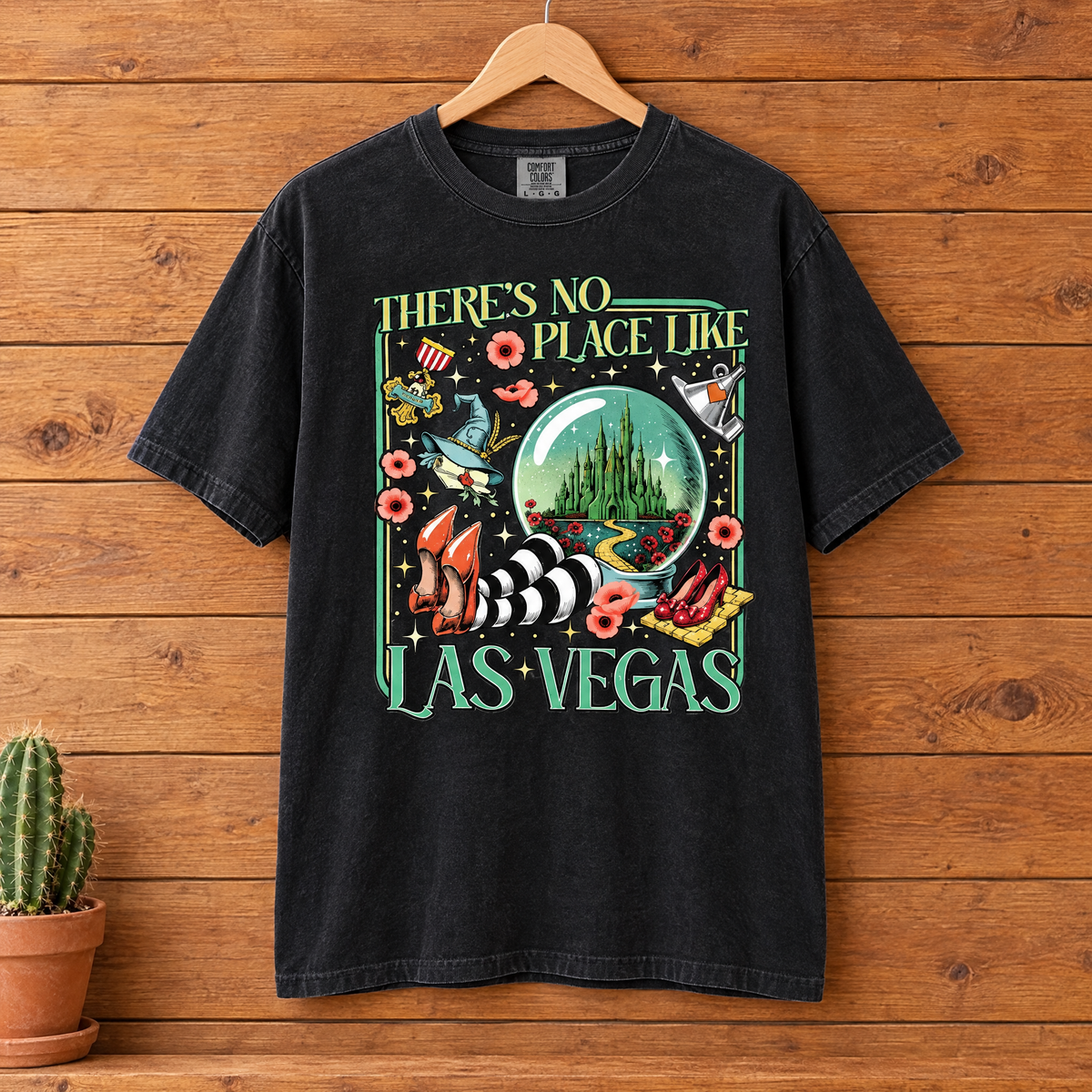 There's No Place Like Las Vegas Comfort Colors shirt in Black on a wooden hanger, front view