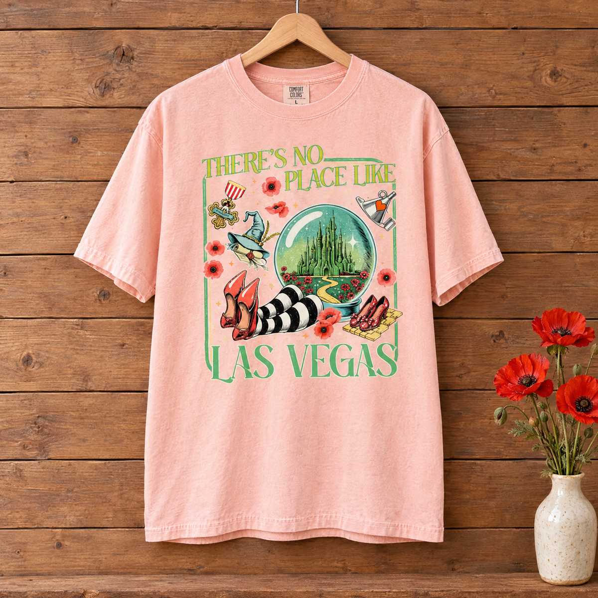 There's No Place Like Las Vegas Comfort Colors shirt in Peachy on a wooden hanger