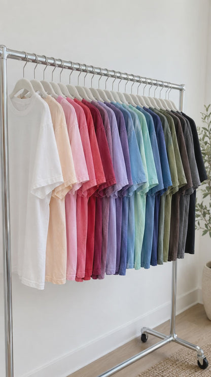 Comfort Colors t-shirts in many colors on a rack and folded in a stack