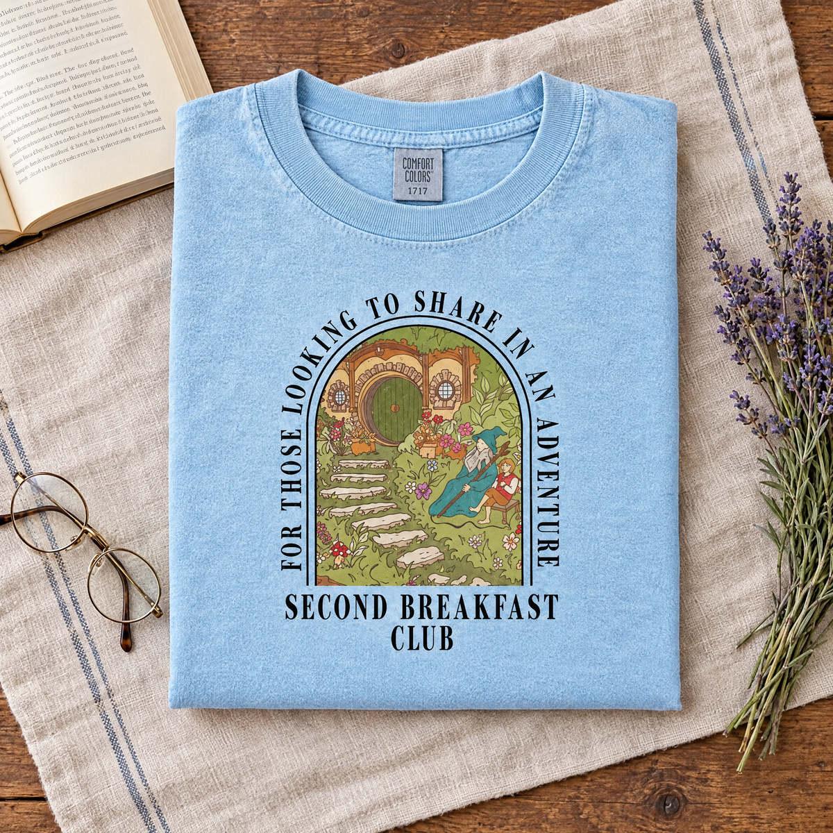 Second Breakfast Club book lover tee in Chambray, folded with a book and reading glasses