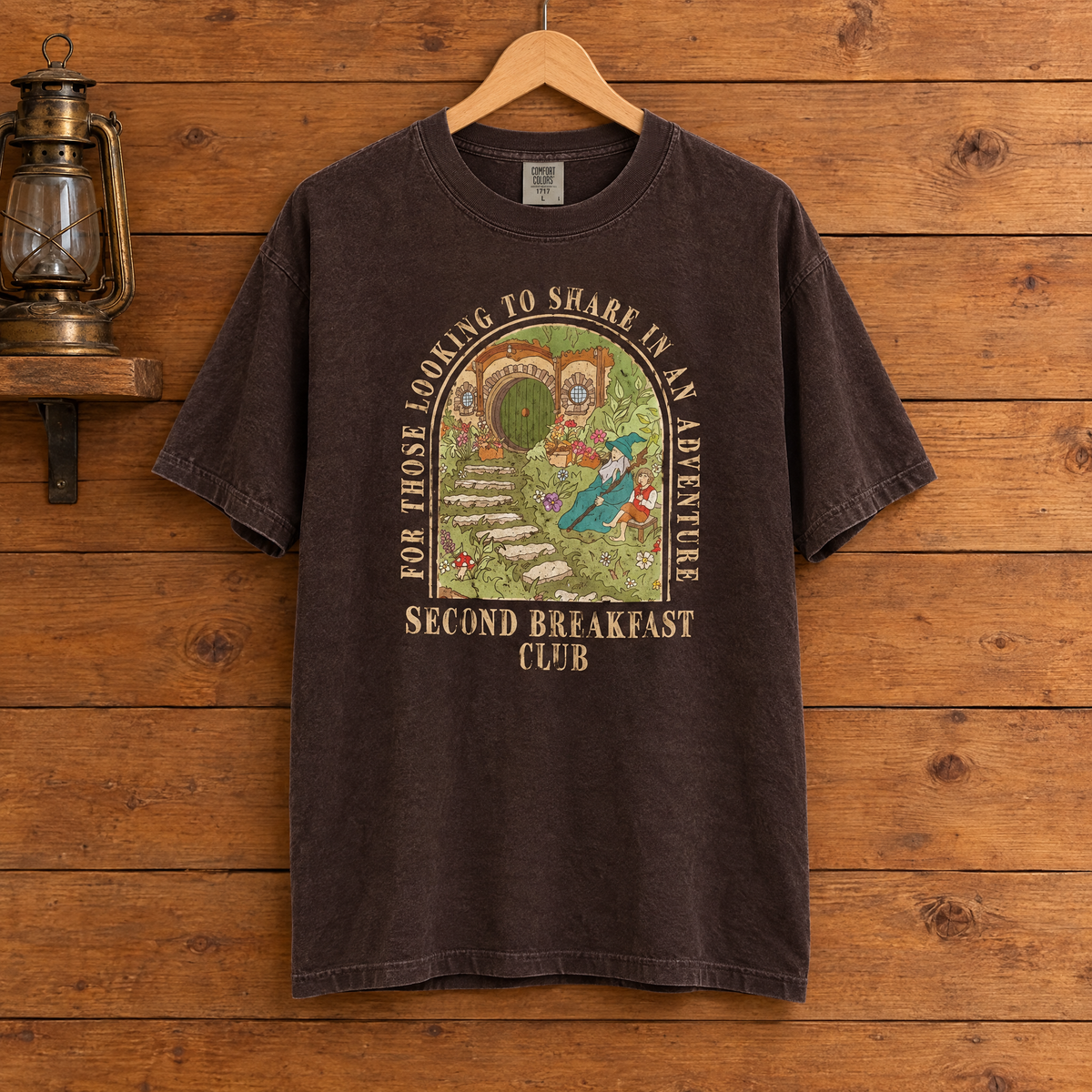 Second Breakfast Club Comfort Colors shirt in Espresso on a wooden hanger