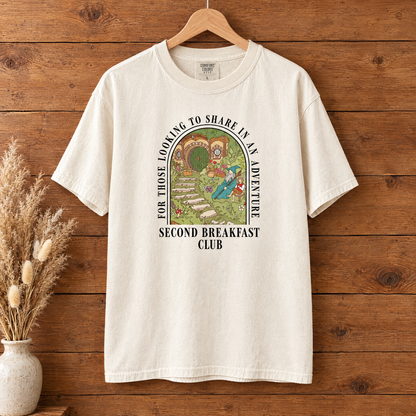 Second Breakfast Club Comfort Colors shirt in Natural Ivory on a wooden hanger