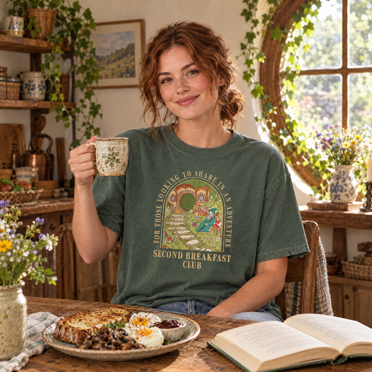 Woman wearing Moss Comfort Colors Second Breakfast Club fantasy book lover shirt at a cozy cottage breakfast table