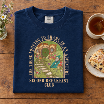 Second Breakfast Club fantasy bookish tee in Navy, neatly folded with tea and a scone