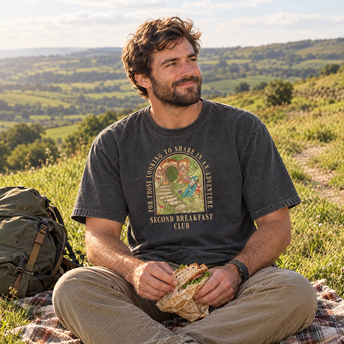 Man wearing Pepper Comfort Colors Second Breakfast Club shirt on a countryside hike picnic