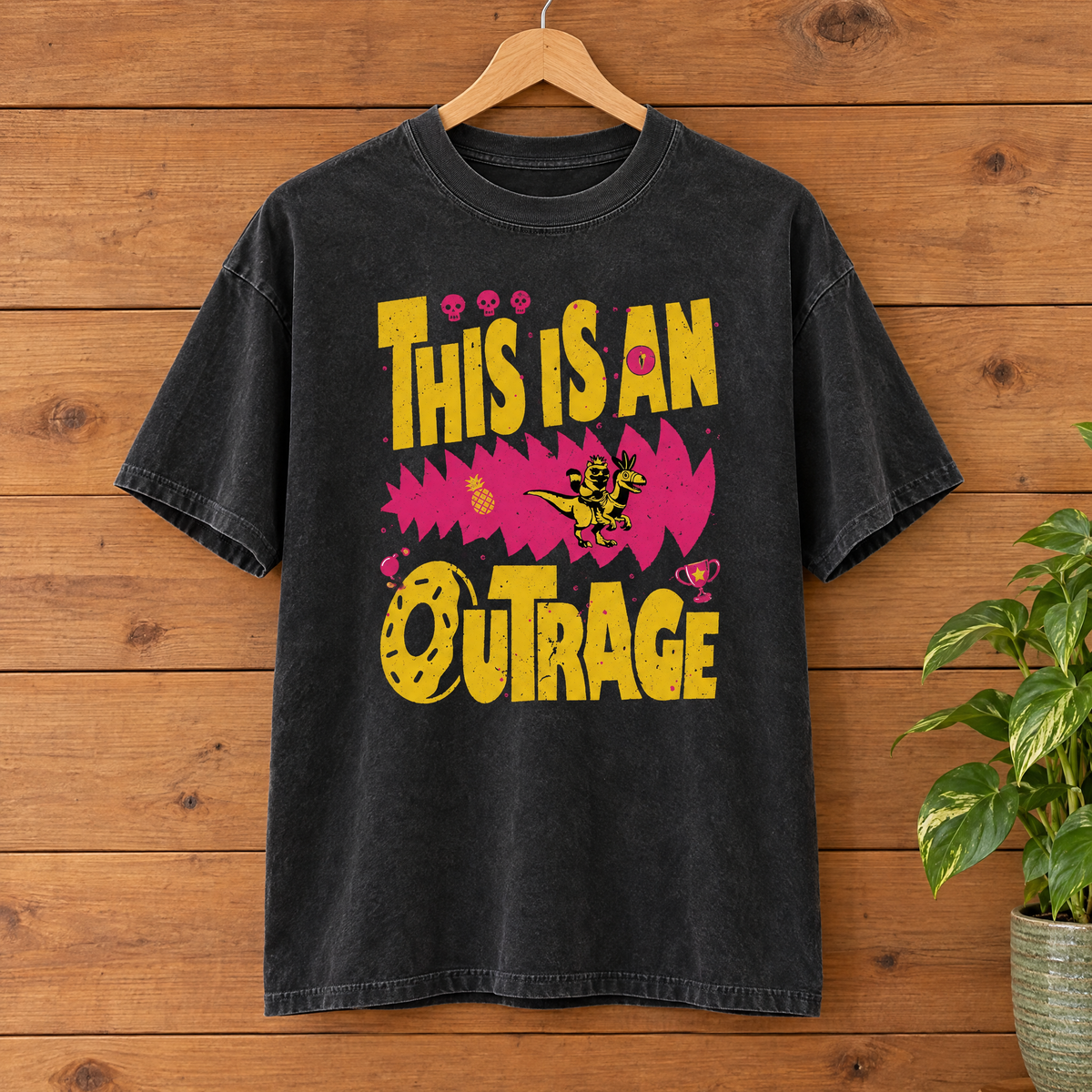 This Is An Outrage Comfort Colors shirt in Black on a wooden hanger