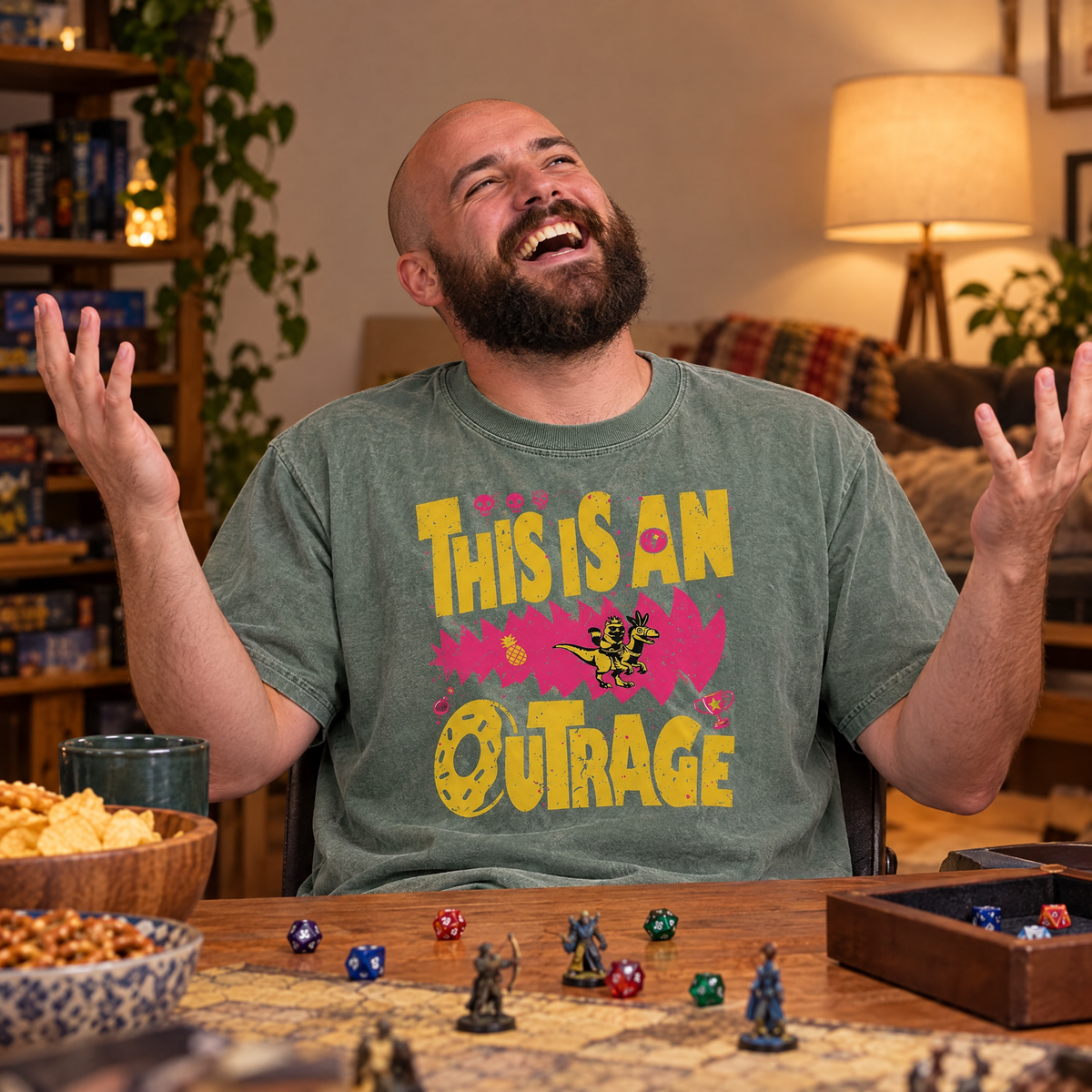 Man wearing Sage Comfort Colors This Is An Outrage shirt at a tabletop game night