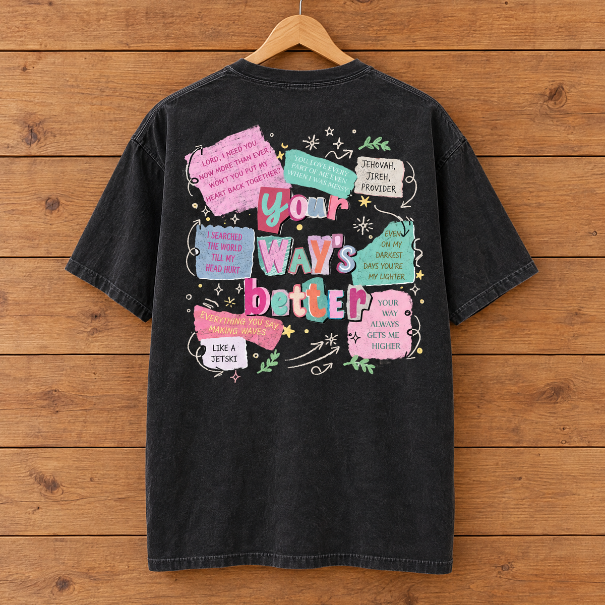 Back collage print of the Your Way's Better Comfort Colors shirt in Black on a hanger